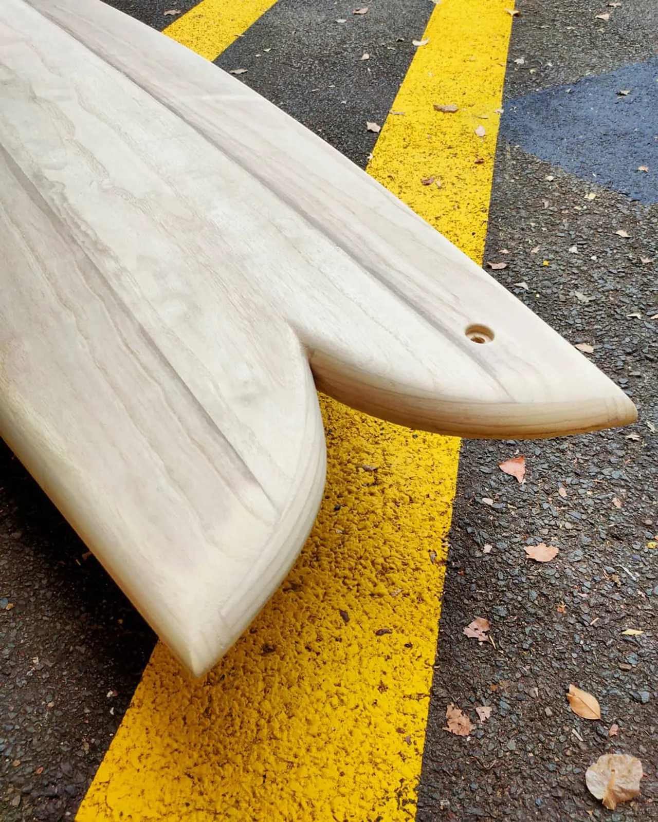 Swallow tail of a hand-built hollow wooden fish surfboard in Paulownia